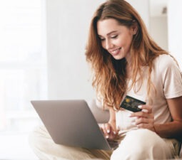 youngconfidentprettywomanworkingwithlaptopandcreditcard