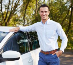 handsomemanstandingleaningoncar