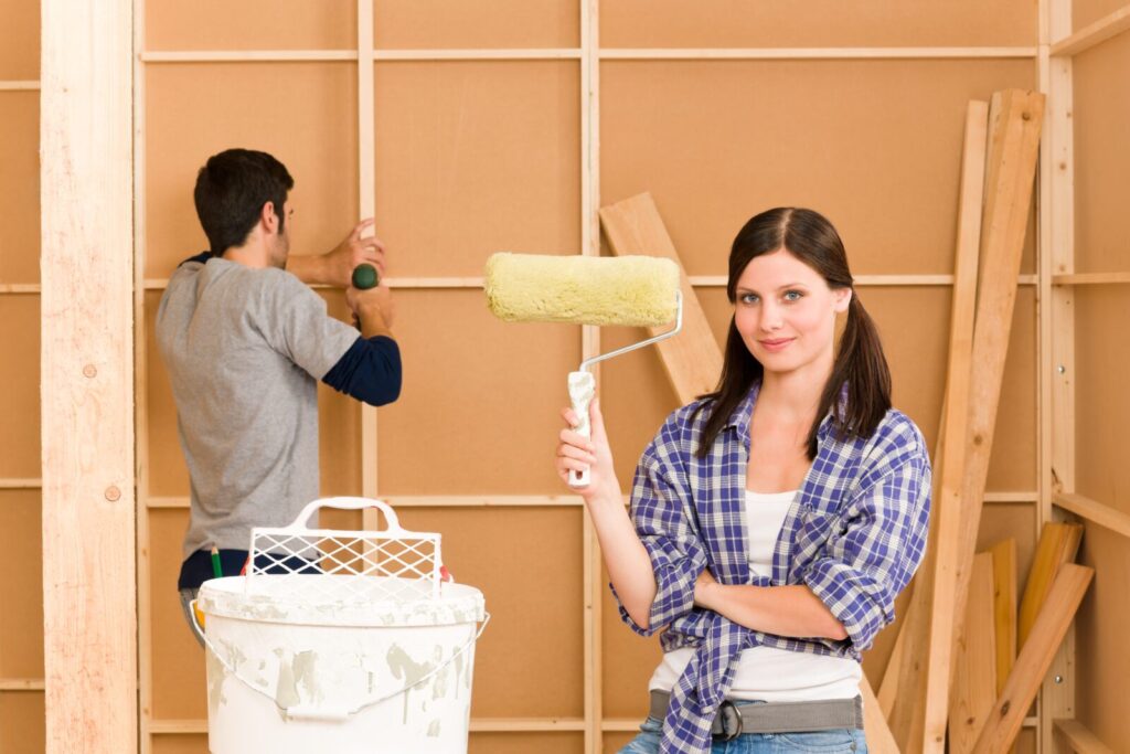 homeimprovementyounghappycouplefixingnewhouserenovatingwall
