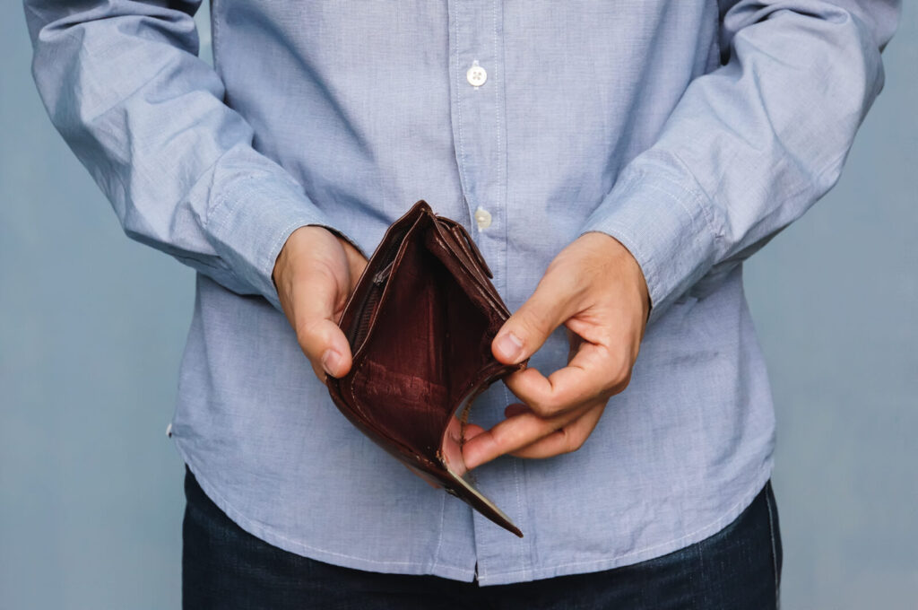 bankruptcy-businesspersonholdinganemptywallet-manshowing