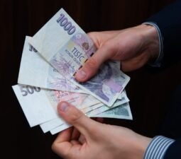 abusinessmanisholdingczechkorunaofvariousdenominationsin