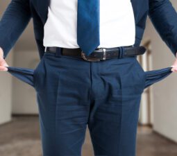 closeupofmalerealtorshowinghisemptysuitpocketsas