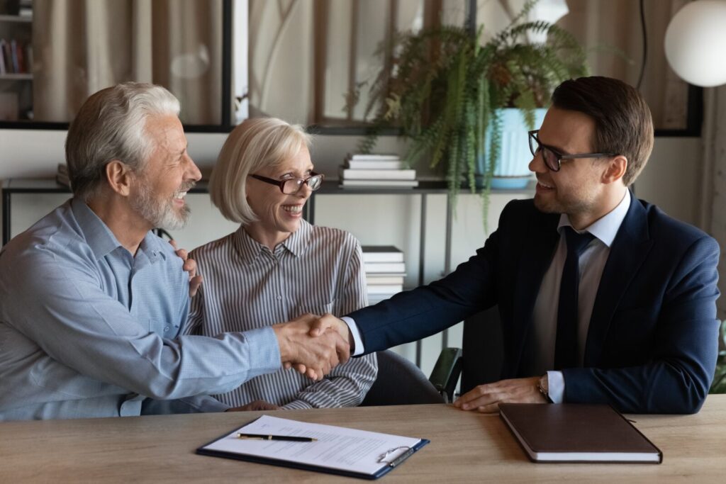 shakinghands-smilingyoungmanrealestatebrokerhandshakingwith