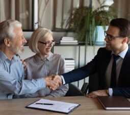 shakinghands-smilingyoungmanrealestatebrokerhandshakingwith